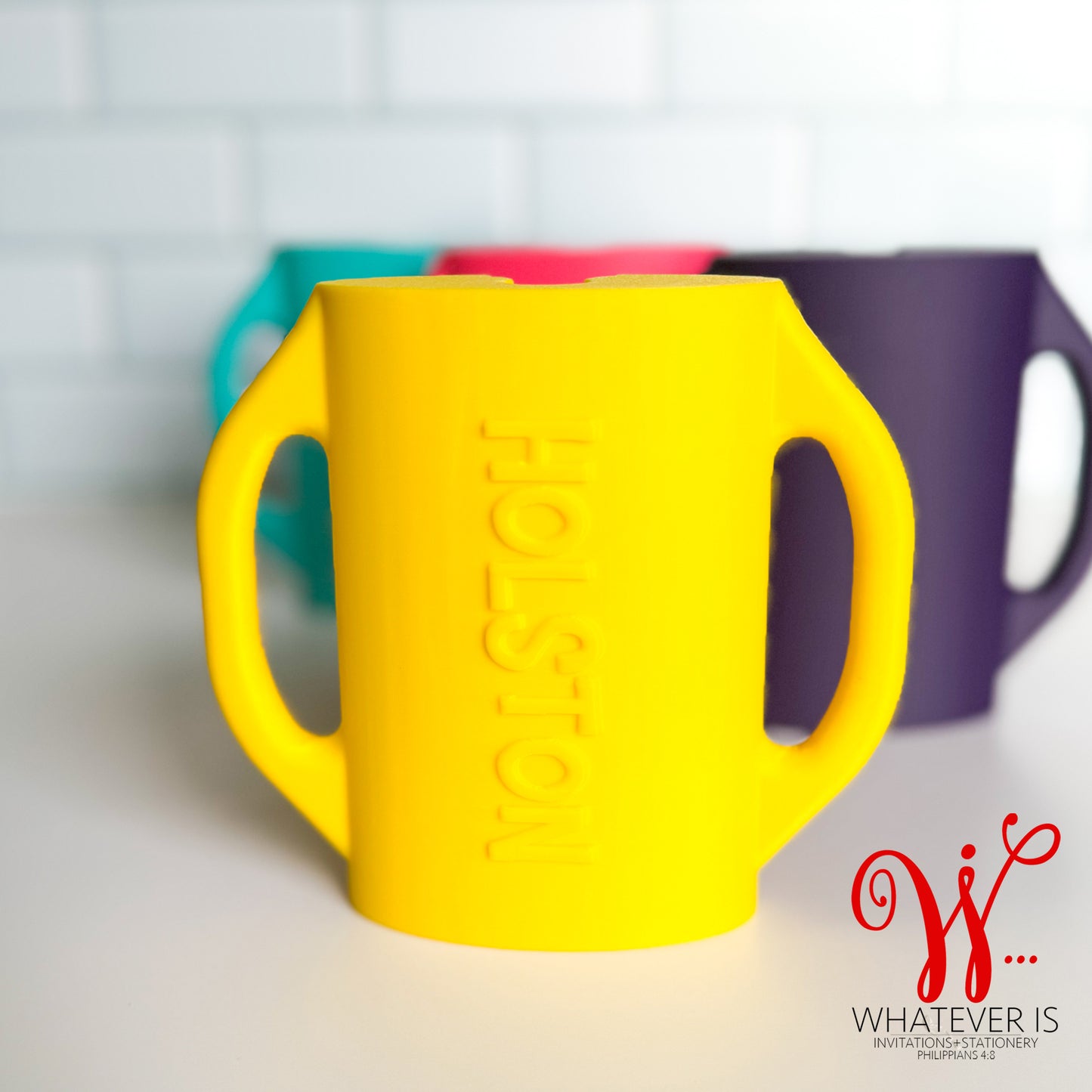 personalized yellow baby food pouch holders with easy-grip handles designed to prevent toddlers from squeezing yogurt and puree pouches and making a mess.