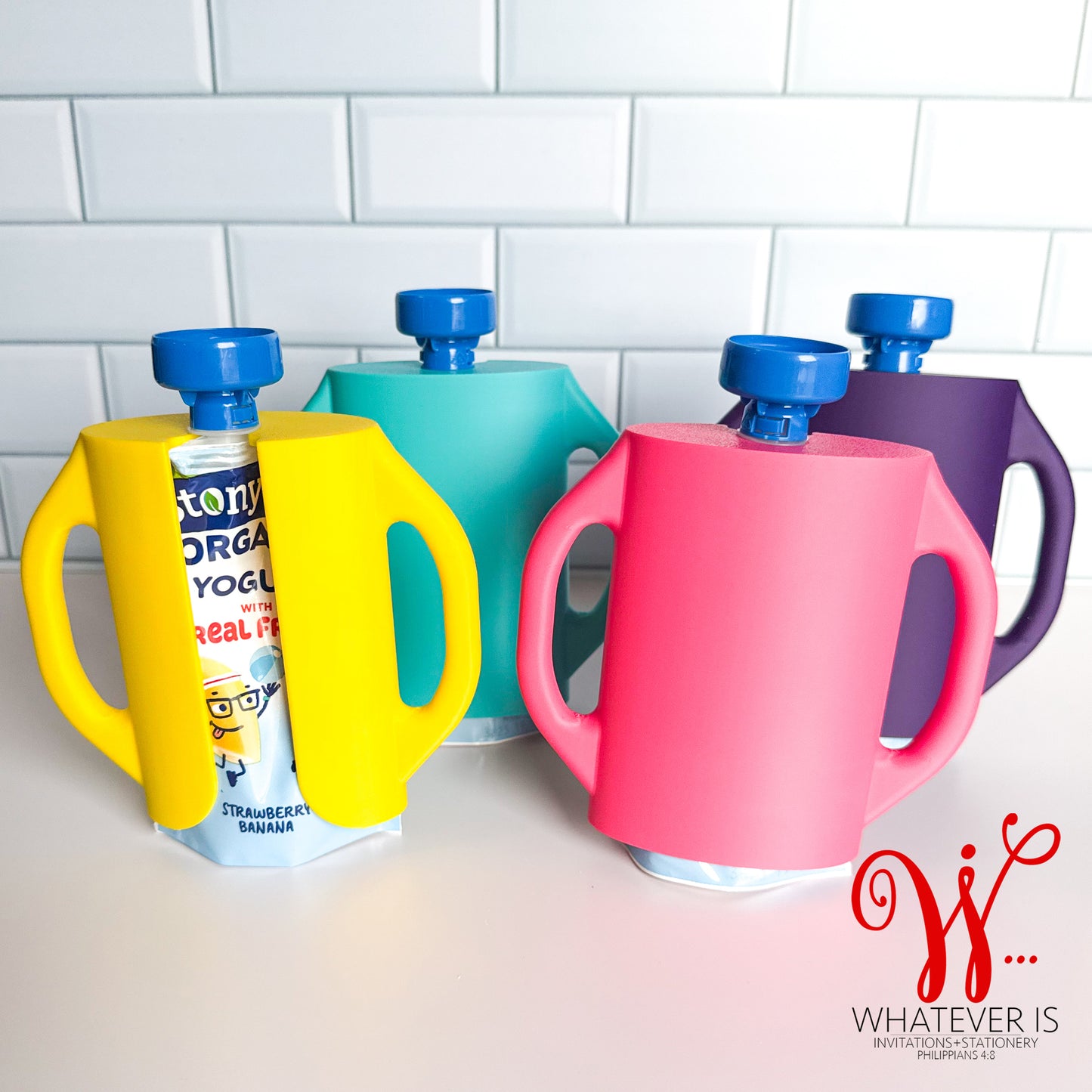 Colorful baby food pouch holders with easy-grip handles designed to prevent toddlers from squeezing yogurt and puree pouches and making a mess.